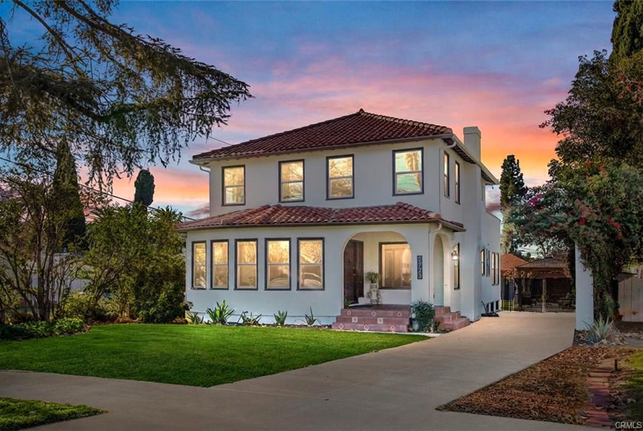 Renovated two-story Spanish-style home at sunset